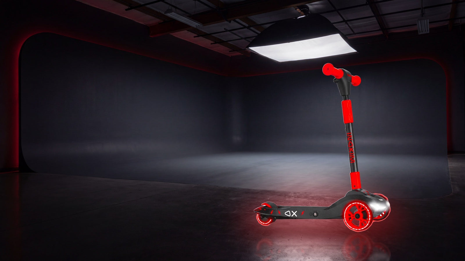 INOKIM OX Junior Carbon red with its lights on